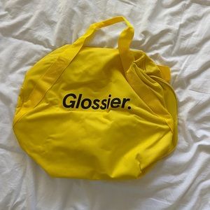 Glossier yellow duffle bag